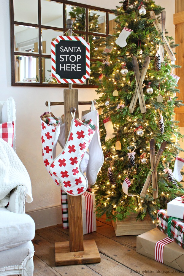 'Santa Stop Here' sign serves as a stocking hanger, too! 